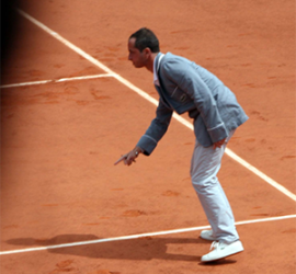 Umpire Pascal Maria gestures on clay tennis court