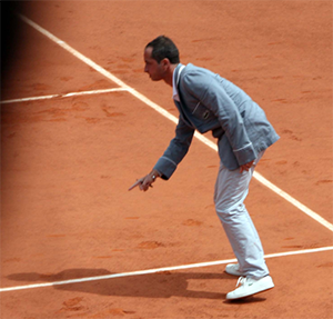 Umpire Pascal Maria gestures on clay tennis court