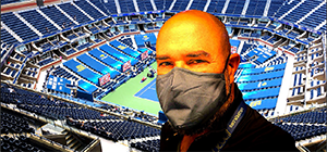 Man with mask overlooking tennis stadium