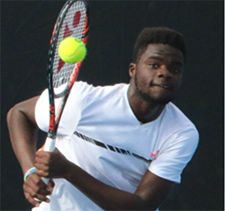 Frances Tiafoe swinging racket during match