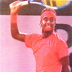 Mikael Ymer smiling and raising racket