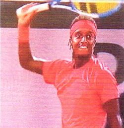 Mikael Ymer smiling and raising racket