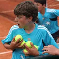 boy holding tennis balls
