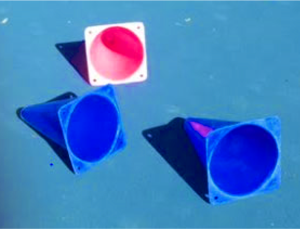 Red cones and blue cones fallen on blue tennis court